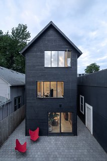 At the rear of the house, the garage and the adjacent warehouse form a secluded courtyard the owners enjoy as an extension of the dining room.