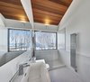 Modern home with Bath Room, Corner Shower, Ceramic Tile Floor, Engineered Quartz Counter, Accent Lighting, Wall Lighting, Drop In Sink, Wall Mount Sink, Subway Tile Wall, Two Piece Toilet, Full Shower, Porcelain Tile Wall, Enclosed Shower, Ceiling Lighting, One Piece Toilet, Porcelain Tile Floor, Open Shower, and Ceramic Tile Wall. Master shower with a view Photo 10 of Laurentian Ski Chalet