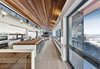Modern home with Kitchen, Medium Hardwood Floor, Wall Oven, Refrigerator, White Cabinet, Wood Counter, Ceiling Lighting, Undermount Sink, Light Hardwood Floor, Wall Lighting, Granite Counter, and Cooktops. Overall view of main living space. Photo 4 of Laurentian Ski Chalet