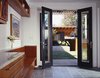 A view from the kitchen to the garden shed and board form concrete water feature. By RobitailleCurtis Photo 6 of Fitler Square House & Garden modern home