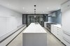 Modern home with Kitchen, White Cabinet, Ceramic Tile Backsplashe, Concrete Floor, Recessed Lighting, Pendant Lighting, Range, Range Hood, Undermount Sink, Refrigerator, Ceiling Lighting, Engineered Quartz Counter, and Accent Lighting. Sleek white kitchen with Heath tile backsplash Photo 6 of Atrium Townhome