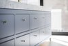 Modern home with Kitchen, Marble Counter, Undermount Sink, Colorful Cabinet, and Light Hardwood Floor. Close-up view of custom kitchen island designed by RobitailleCurtis, built by Kastella. Island has a 4" Carrara marble counter. Drawers fronts received a subtle but effective bead detail at top and bottom. Pulls are by School House Electric. Photo 7 of Hampstead House