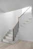 Minimal stair with ash treads, white painted risers, black steel pickets, and an ash handrail. Photo 12 of Hampstead House modern home