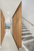 Modern home with Hallway and Concrete Floor. View towards second floor den and stair to third level. Photo 18 of Atrium Townhome