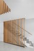 Stair to basement and second floor. Stair treads are St. Marc Stone. Wood Screen is Douglas Fir. Photo 16 of Atrium Townhome modern home