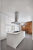 Modern home with Kitchen, Ceiling Lighting, Cooktops, Range Hood, Porcelain Tile Floor, Engineered Quartz Counter, Range, Pendant Lighting, White Cabinet, Stone Slab Backsplashe, Dishwasher, Recessed Lighting, and Undermount Sink. Custom cabinetry was designed by RobitailleCurtis, built by Kastella. Photo 6 of Winchester Residence