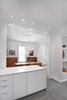 Modern home with Kitchen, Recessed Lighting, Porcelain Tile Floor, Ceiling Lighting, Medium Hardwood Floor, Engineered Quartz Counter, White Cabinet, and Pendant Lighting. View from the kitchen into the dining room. Photo 7 of Winchester Residence