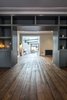 Modern home with Living Room, Lamps, Table, Shelves, Chair, Accent Lighting, Ceiling Lighting, Dark Hardwood Floor, Wood Burning Fireplace, and Gas Burning Fireplace. Hidden sliding pocket doors allow the feeling of openness but also snug, private areas. Photo 2 of THE GLASSHOUSE