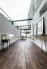 Modern home with Dining Room, Chair, Table, Ceiling Lighting, and Dark Hardwood Floor. The glass panels had to be made in Germany and craned into place Photo 3 of THE GLASSHOUSE