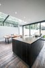Modern home with Kitchen, Engineered Quartz Counter, Concrete Counter, Wood Cabinet, Dark Hardwood Floor, Concrete Backsplashe, Undermount Sink, and Ceiling Lighting. Reclaimed wood together with high specification hand made kitchen furniture blend the old and the new beautifully Photo 4 of THE GLASSHOUSE