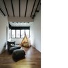 The room with lots of natural light streaming in, to lounge in. It's a multi-purpose room - to exercise, to read in etc. All the wooden beams are original. The owners wished to retain the old charm of this pre-war home, while introducing new elements of modernity. Photo 9 of The Singapore Designer Loft: A Fusion of Old and New modern home