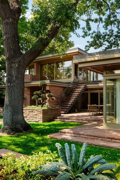 Native red sandstone forms compelling interconnections among walls, planters and terraces. The exterior staircase, fabricated out of steel with sandstone treads, originally led to a rooftop solarium, which did not survive decades of water damage and subsequently was replaced with a guest suite. Kale and tomato spring from a raised sandstone bed, one of four that Boulder-based Marpa established in its historically sensitive landscape design for the property.