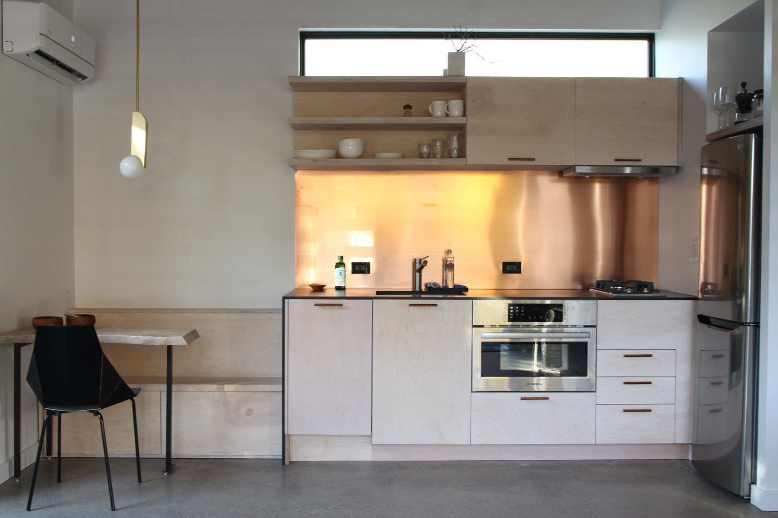 The kitchen features a real copper backsplash and built in dinette bench