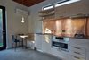 Modern home with Kitchen. The kitchen features a real copper backsplash and built in dinette bench Photo 9 of The Mansfield Frogner House