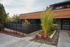Modern home with Exterior. The slatted fence in front of the ADU patio provides some privacy Photo 15 of The Mansfield Frogner House