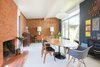 Modern home with Dining Room, Chair, Ceiling Lighting, Table, and Vinyl Floor. Restoration projects included restoring the original fireplace brickwork and re-instating details such as wood paneling and original Eichler pinstripe siding. Photo 2 of Walnut Creek Eichler Renovation