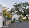 Modern home with Outdoor, Shrubs, Walkways, Grass, Trees, Gardens, Front Yard, and Landscape Lighting. Entry drive court Photo 2 of Hilltop Haven