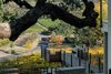 Modern home with Outdoor, Trees, Shrubs, Gardens, Metal Patio, Porch, Deck, Grass, Wood Patio, Porch, Deck, and Decking Patio, Porch, Deck. View to the estate entry Photo 10 of Hilltop Haven