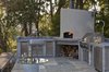 Modern home with Outdoor, Back Yard, Trees, Hardscapes, and Stone Patio, Porch, Deck. An outdoor kitchen with pizza oven is conveniently located adjacent to the interior kitchen Photo 6 of Hideaway View