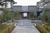 Modern home with Outdoor, Front Yard, Trees, Shrubs, Grass, Hardscapes, Stone Patio, Porch, Deck, Concrete Patio, Porch, Deck, and Landscape Lighting. Entry courtyard at twilight Photo 8 of Hideaway View