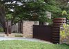 Modern home with Outdoor, Trees, Shrubs, Grass, Gardens, Hardscapes, Front Yard, and Stone Patio, Porch, Deck. A composition of stone and corten steel demarcates the private from the public. Stone walls provide structure and privacy. The tower celebrates the arrival and houses the sliding gate operator. Photo of On the Edge