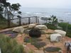 Modern home with Outdoor, Shrubs, Trees, Back Yard, Hardscapes, Stone Patio, Porch, Deck, Gardens, Boulders, and Metal Fences, Wall. Elements in the landscape such as wall benches, stairway landings, a belvedere overlook and the seat rocks at the fire pit area shown here provide opportunities to stop and take in the view. Photo 4 of On the Edge
