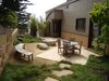Modern home with Outdoor, Side Yard, Garden, Trees, Shrubs, Gardens, Grass, Hardscapes, Boulders, Decomposed Granite Patio, Porch, Deck, Concrete Patio, Porch, Deck, and Stone Patio, Porch, Deck. A quiet, sheltered outdoor dining area Photo 13 of On the Edge