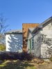 Modern home with Exterior, House Building Type, Hipped RoofLine, Metal Siding Material, Gable RoofLine, Wood Siding Material, Concrete Siding Material, Shingles Roof Material, and Stucco Siding Material. Exterior Side View - After re-model Photo 7 of Crestwood Re-Model