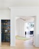 Modern home with Hallway and Light Hardwood Floor. Elevator with hand painted mural and brass bar cart. Photo 10 of Sea Cliff Preppy Contemporary