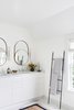 Modern home with Light Hardwood Floor. Master bathroom with modern round mirrors and towel ladder. Photo 19 of Sea Cliff Preppy Contemporary