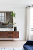 Modern home with Living Room, Console Tables, Sectional, Light Hardwood Floor, and Standard Layout Fireplace. Dark wood credenza in living room. Photo 5 of Sea Cliff Preppy Contemporary