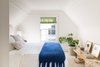 Modern home with Light Hardwood Floor. Guest bedroom with white bedding and bright blue throw. Photo 20 of Sea Cliff Preppy Contemporary