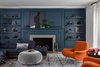 Modern home with Living Room, Chair, Light Hardwood Floor, Standard Layout Fireplace, Sectional, and Sofa. Living Room with tone-on-tone navy walls and and accent chairs upholstered in Hermes fabric. Photo 2 of Sea Cliff Preppy Contemporary