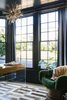 Modern home with Shelves, Storage, Chair, and Light Hardwood Floor. Home office with navy blue walls and drapery. Photo 15 of Sea Cliff Preppy Contemporary