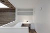 Modern home with Office, Study Room Type, Medium Hardwood Floor, Shelves, and Chair. Home office Photo 9 of Flipped House