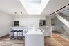 Modern home with Kitchen, Undermount Sink, Medium Hardwood Floor, Quartzite Counter, Wall Oven, Refrigerator, White Cabinet, and Cooktops. Main floor / Kitchen & Living Area Photo 3 of Gazing House