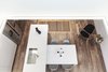 Modern home with Kitchen, White Cabinet, Undermount Sink, Medium Hardwood Floor, and Quartzite Counter. Second floor / Shaft / Looking towards the living area via the void Photo 5 of Gazing House
