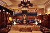Modern home with Living Room, Ottomans, Sofa, Table Lighting, and Ceiling Lighting. A straight walk past reception and Café Integral leads to the elevators, which also serves as the entrance to Freehand Chicago’s den. It’s as cozy and dimly lit as you could ever hope, as well as thoughtfully designed with the aesthetic of Chicago and Lake Michigan in mind. Sofas and leather chairs line the perimeter to create pockets of communal lounge spaces, with wood-paneled walls, fireplaces, books, and games making it feel more like a living room than a hotel. A Wurlitzer electric keyboard frames the nook where Freehand hosts musicians, creating an ambiance as conducive to creativity as a celebrated neighborhood coffee shop.
Up a few steps, behind the den and past the DJ booth, is the Broken Shaker, a mixology bar serving drinks like the Chicago Dog Margarita and the Chi City Mule in glasses as beautiful as the cocktails are delicious. The bar walls are covered with pine tree wallpaper, and the relaxed and refined aesthetic is prevalent in both ambiance and flavor, with local Midwestern ingredients purposing the menu items. Rooms aside, the Freehand Chicago is the place to be in the city’s burgeoning River North neighborhood. Photo 3 of Freehand Chicago