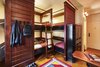 Modern home with Bedroom, Rug Floor, Wall Lighting, and Bunks. This hotel and hostel hybrid is the second installment of Sydell Group’s Freehand Hotel collection, and is equipped with both private and shared rooms for a total of 336 beds on the property. Eighty rooms are shared format, offering four bunk beds and lockers per room; each bed has a private charging station, lamp, and reading shelf.
Design firm Roman and Williams led creative direction of the interiors, manifesting an immediate sense of Chicago in the rooms and communal living spaces. Woven fabric instillations commissioned by local artisans adorn each private room, squarely centered above the beds to create a striking sense of place, capturing Midwestern pastimes like quilting circles and sewing bees in a fresh, modern, design-forward way. Photo 4 of Freehand Chicago
