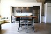 Antique drafting table at same height as counters acts as an island. National Public Seating stools match the rest of the grey colour scheme. Photo 2 of Silver Lining Loft modern home