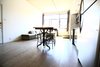 Looking out from the far end of the main living space, a bank of windows spans nearly the full width of the front facade. Photo 3 of Silver Lining Loft modern home