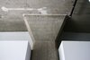 An exposed concrete column divides the volume of the kitchen and the one for the bathroom. The 12-foot ceilings still show the impressions of the stringers used for the building's formwork . Photo 6 of Silver Lining Loft modern home