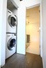 A stacked washer and ventless dryer fit in a closet with a bifold sliding door. Photo 8 of Silver Lining Loft modern home