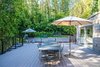 An expansive rear deck surrounded by lush bamboo hedges is a tranquil retreat for dining and lounging. Sliding pocket doors off the kitchen and bedrooms create a seamless connection with the outdoors. Photo 5 of Nichols Canyon modern home