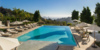 Rivaling the finest resorts in the world, this opulent Mediterranean villa in Beverly Hills showcases 25 acres of outdoor space, including vineyards, a tennis court and pavilion, 128-foot scenic reflecting pool and fountain, and impeccable landscaping. A gorgeous entertainment center with vanishing pocket doors to the pool allows for grand-scale entertaining while enjoying striking sunsets against the iconic L.A. skyline. Photo of Four L.A. Homes with Phenomenal Outdoor Spaces for Spring modern home