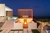 A fire pit enclave on the lower-level courtyard is the perfect place for post-dinner conversation. Photo 8 of Tip of the Tail Villa modern home