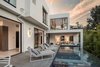 The swimming pool spills over lush canyon views. Photo 6 of Cherokee Contemporary modern home
