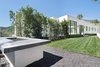 An additional grassy outdoor area with a large fire pit accessible from the second floor is a relaxing and private retreat. Photo 11 of Cherokee Contemporary modern home