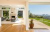 Light-filled living spaces are heightened by large windows, towering walls of glass, and original coffered ceilings Photo 2 of Hillcrest Road modern home