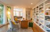 A refined office showcases built in bookshelves and a seamless flow to the living room Photo 6 of Hillcrest Road modern home